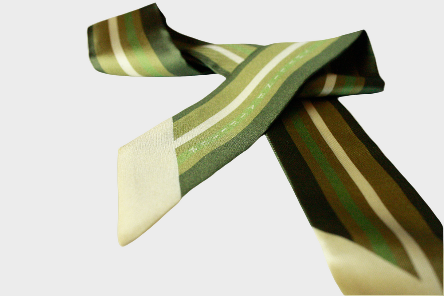 Striped twilly silk scarf with green and beige pattern on a beige background