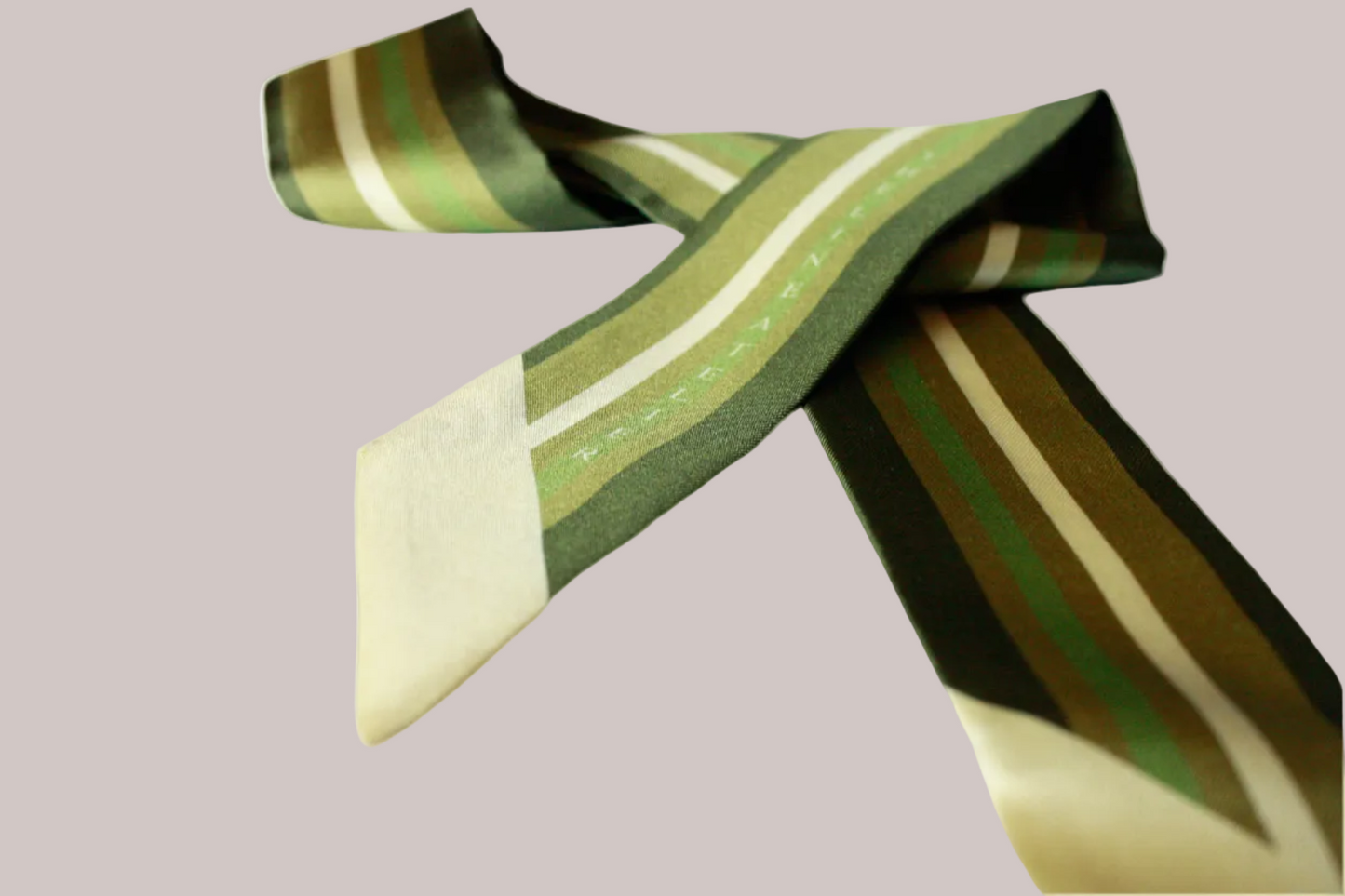 Striped twilly silk scarf with green and beige pattern on a beige background