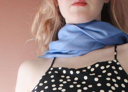 Model wearing blue Ice Valley silk and wool scarf by The Line Atelier