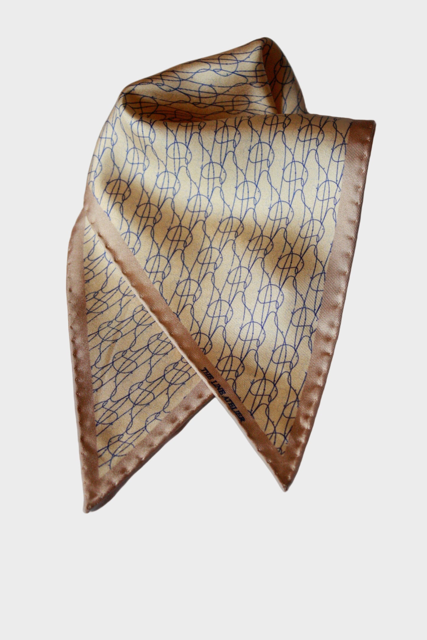 Rogue Of The Sands Diamond Sized Silk Scarf by The Line Atelier In Tan Silk With Abstract Blue Pattern And Hand Rolled Edges