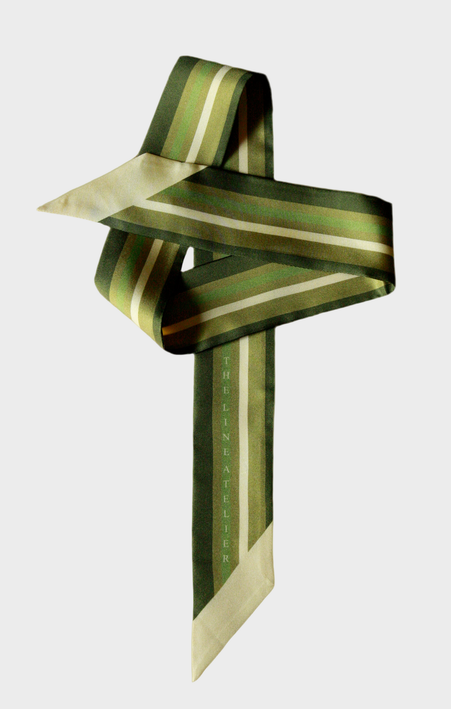 Green and pale gold striped twilly silk scarf on a beige background