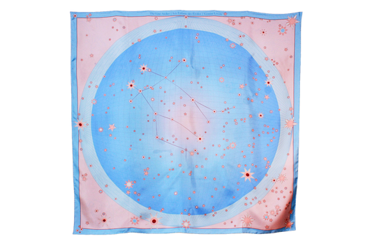 A square silk scarf featuring a celestial design of the Gemini constellation with a large light blue circle, constellation lines, and small stars on a soft pink background, finished with a light blue border and line art of ballet dancers in pairs.