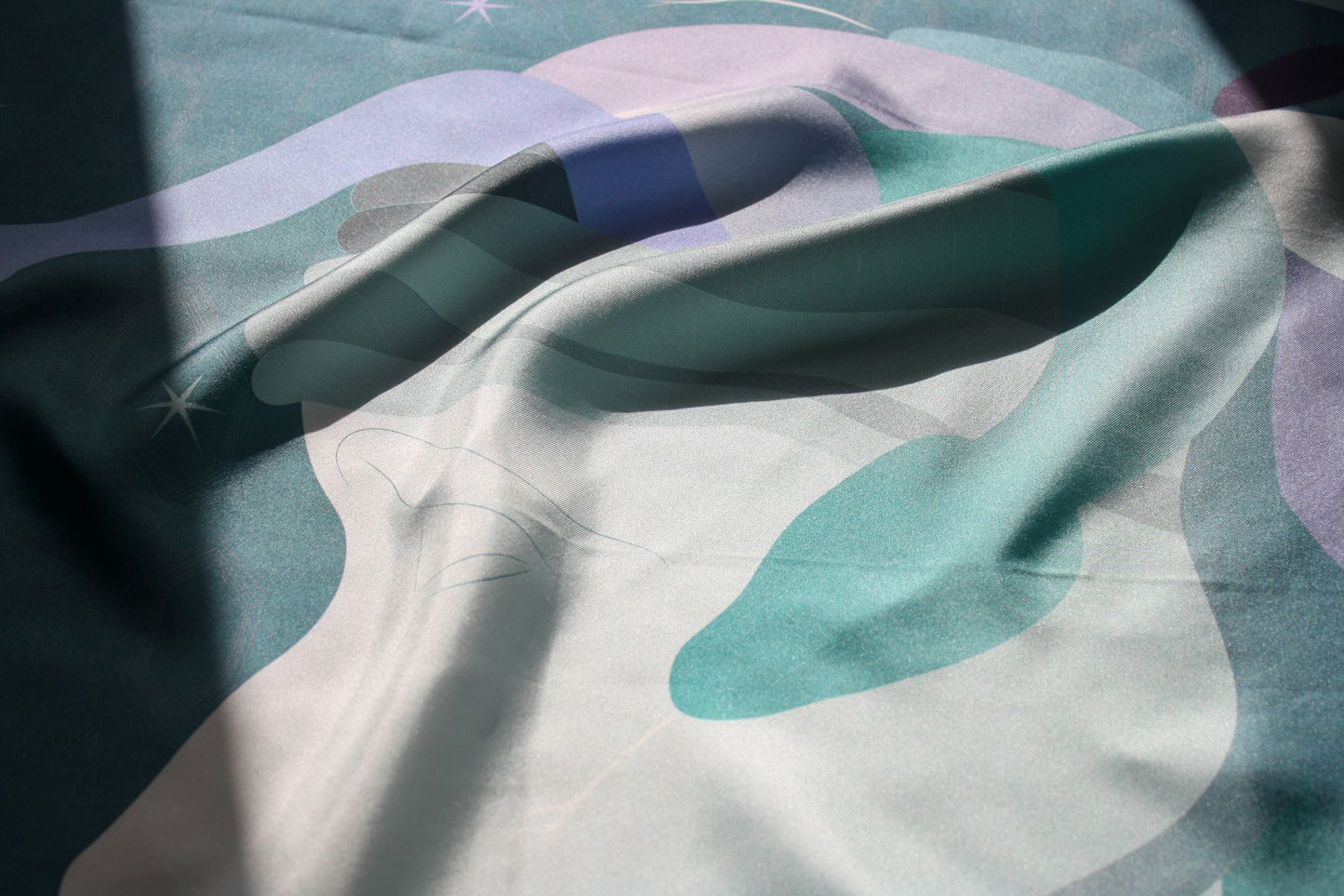 Close up of silk texture of silk scarf Halcyon Medusa in shades of mauve, teal and sage