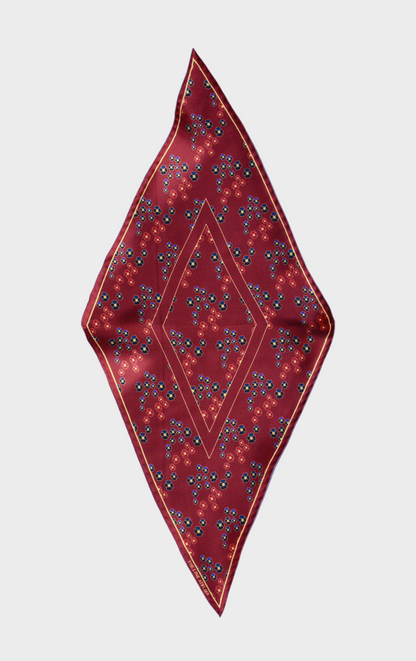 Hearts Ruby silk scarf by The Line Atelier, diamond size, with gem toned pansy flowers on a beige background