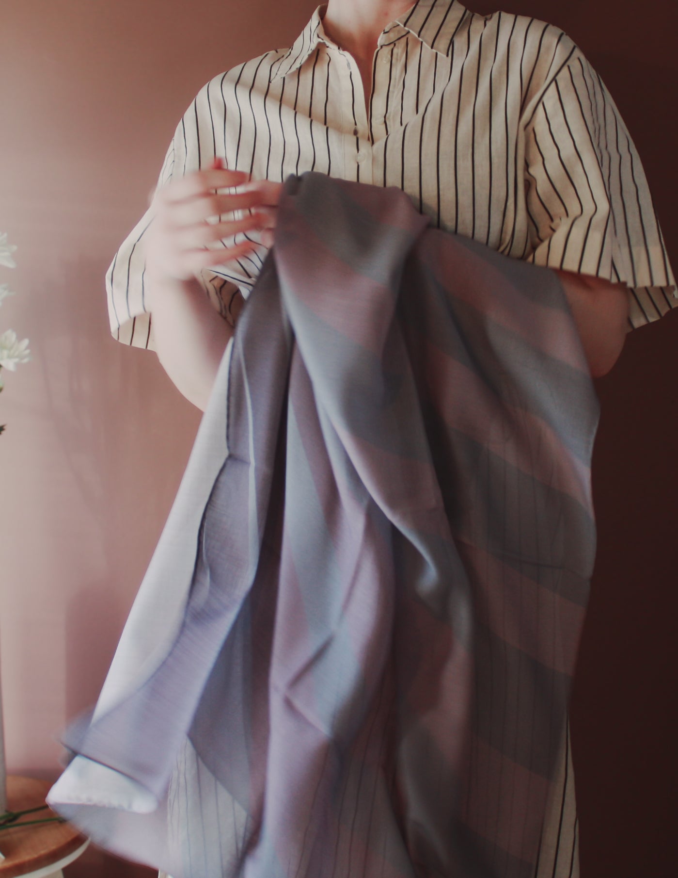 Model holding Love Potion nr 9 Silk & Wool scarf by The Line Atelier against a neutral background