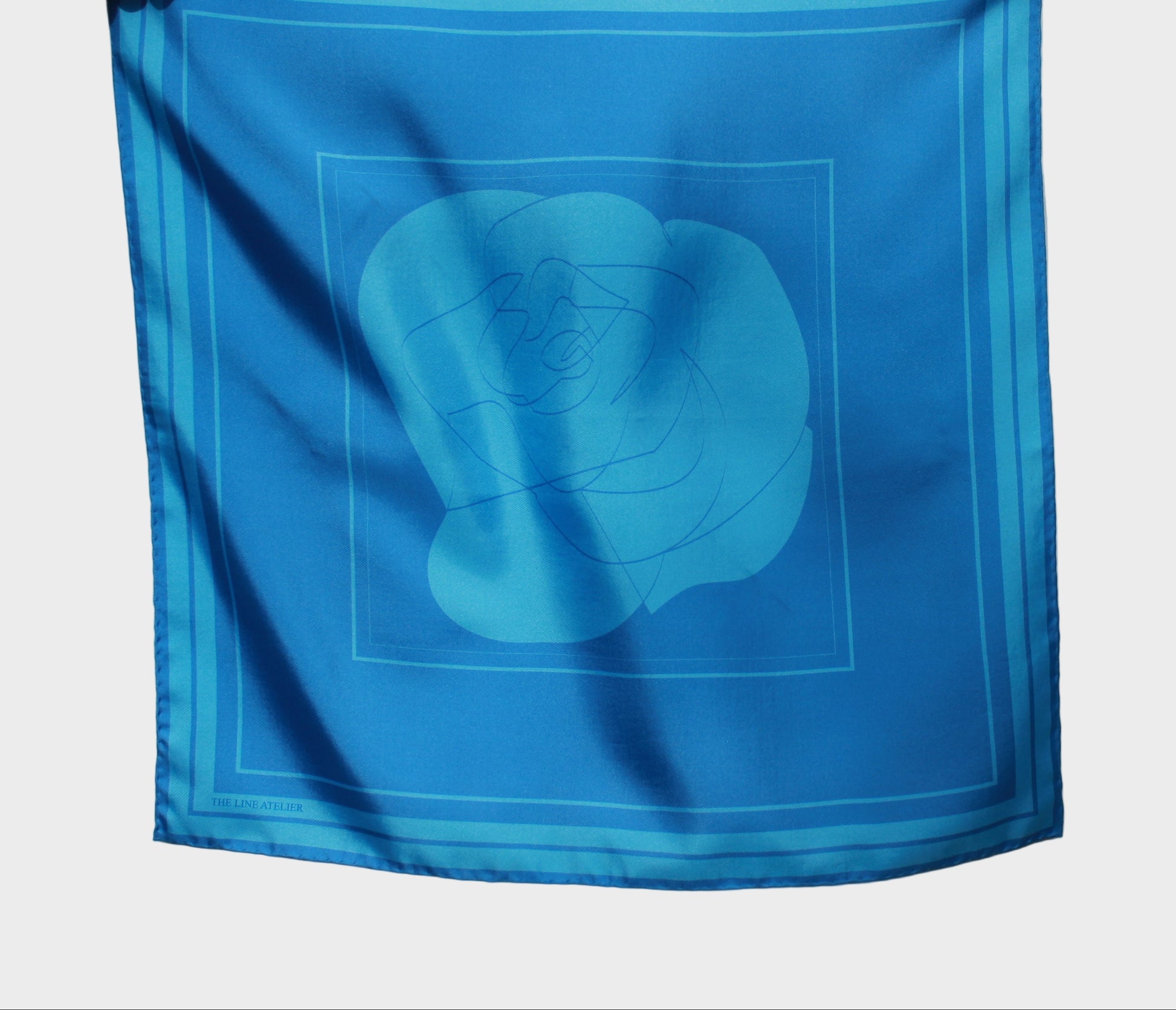 60 x 60 cm sized silk scarf, Midnight Sister, in deep cerulean silk with a large abstract rose motif, hand rolled edges, by The Line Atelier