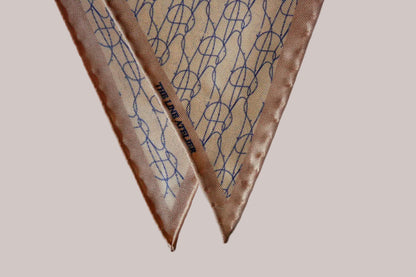 Rogue Of The Sands diamond silk scarf in tan silk with abstract blue pattern and hand rolled edges, detail photo, by The Line Atelier