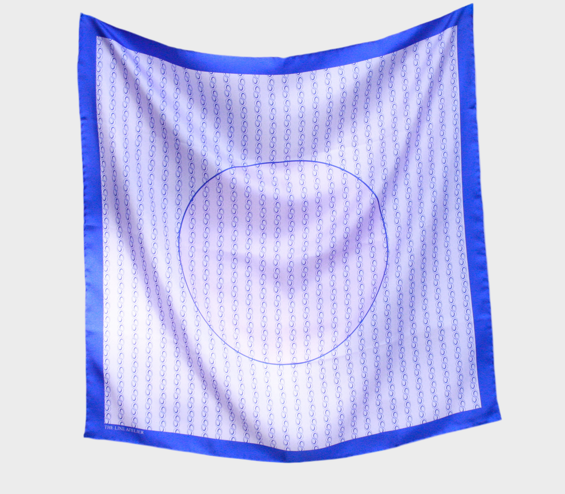 Square scarf with blue border and circular pattern on a beige background