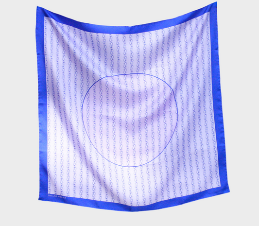Square scarf with blue border and circular pattern on a beige background